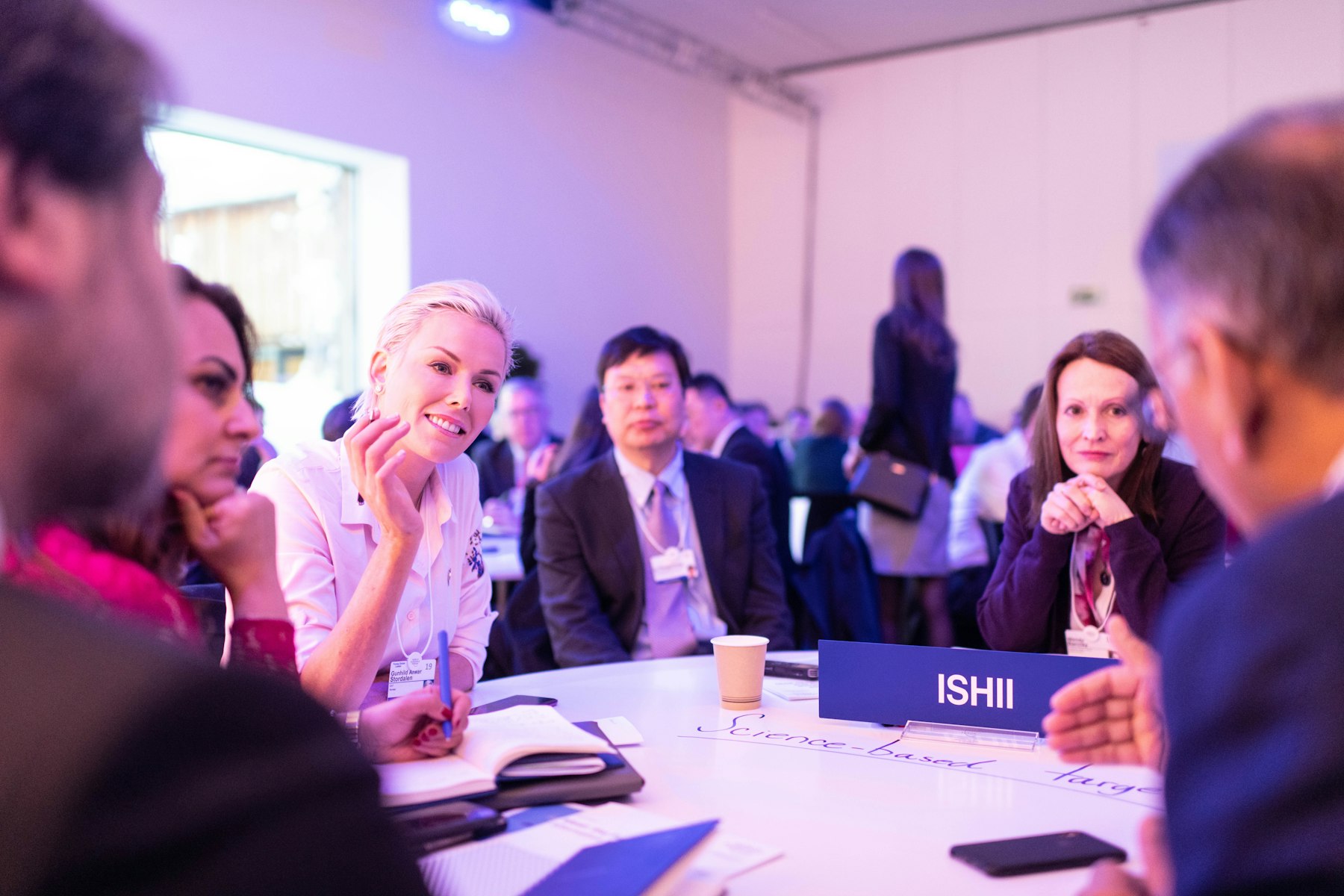 Learners talking and smiling around a table
